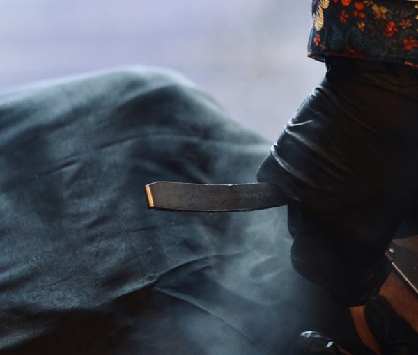 An open razor and steam at the chair