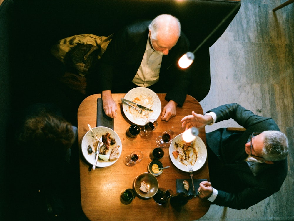 A table of people eating together, seen from above