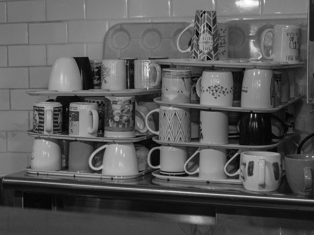 Mugs stacked on the shelf behind the counter